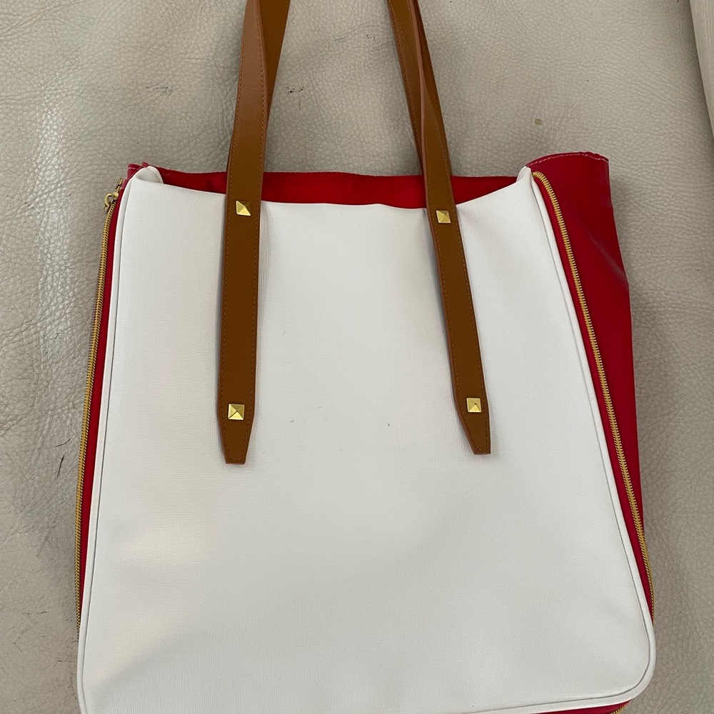 Tote expands 5" with zipper. Waterproof interior.